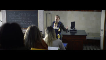 The central character in the one-minute TV spot is a university professor who takes his small grandson to work with him.